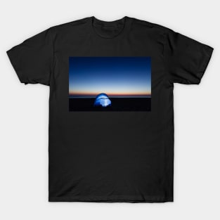 Illuminated tent on the beach by the sea at dawn T-Shirt